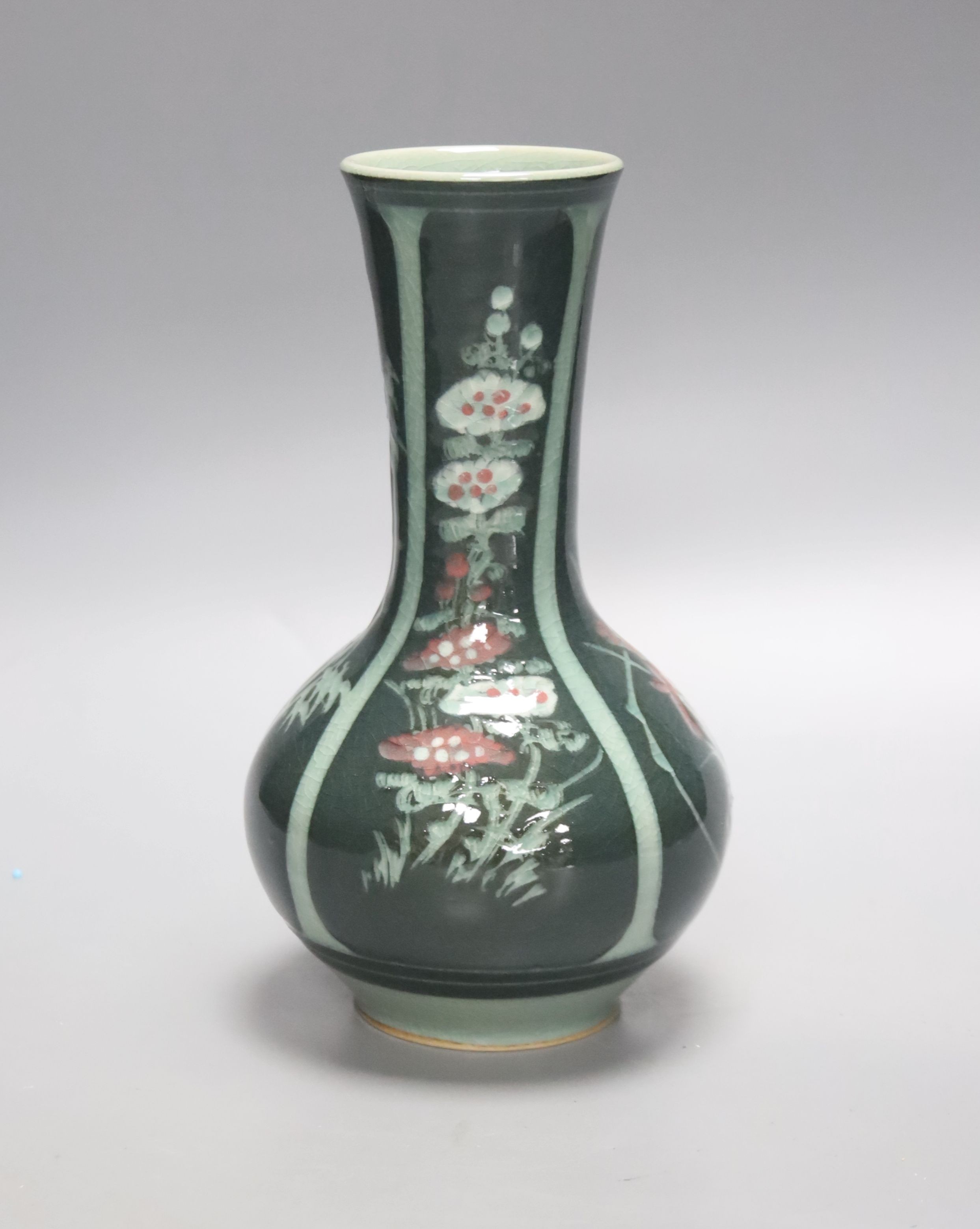 A green Japanese artisan studio vase decorated with flower designs, 20cm tall